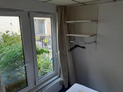 a corner of a room with a window and a shelf at Casa ENRICO in Antwerp