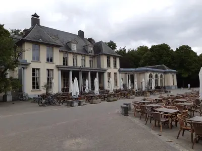 an empty courtyard with tables and chairs in front of a building at Casa ENRICO in Antwerp