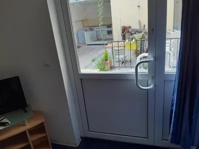 a glass door with a view of a patio at Casa ENRICO in Antwerp