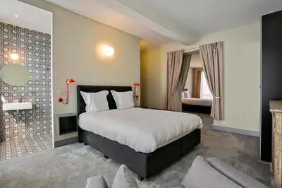 a bedroom with a large bed and a living room at Fish Market B&B in Brussels