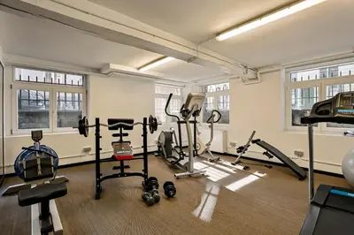 a gym with treadmills and exercise equipment in a building at Fish Market B&B in Brussels