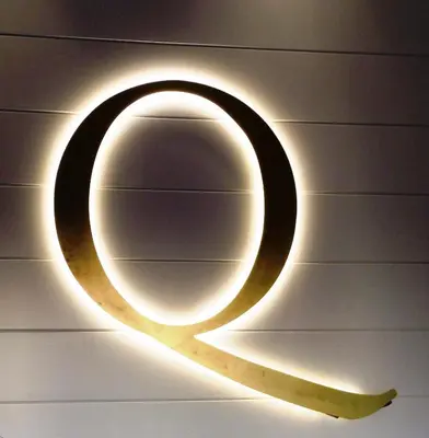 a light up sign hanging on a wall at Quarante Cinq in Evergem