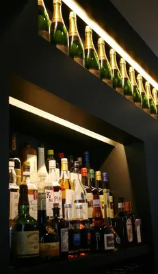 a shelf filled with lots of bottles of alcohol at Quarante Cinq in Evergem