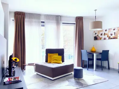a living room with a chair and a table at Quartier des Quais Dansaert in Brussels