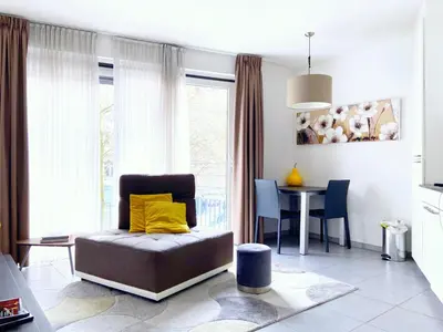 a living room with a chair and a table at Quartier des Quais Dansaert in Brussels