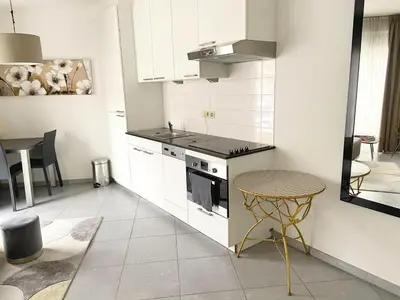 a kitchen with a stove and a table in it at Quartier des Quais Dansaert in Brussels