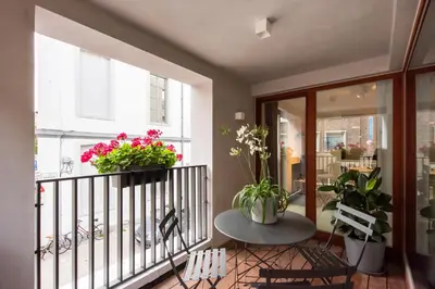 a balcony with two potted plants and a table at Salt & Pepper Ghent in Ghent