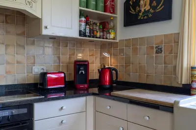 a kitchen with a counter with a toaster on it at Villa De Ruiter in Waasmunster