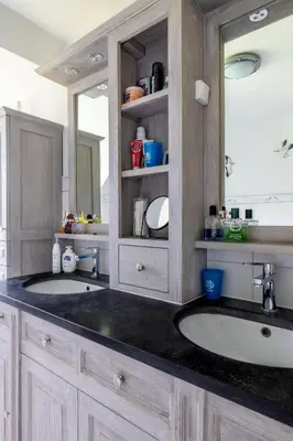 a bathroom with two sinks and a large mirror at Villa De Ruiter in Waasmunster