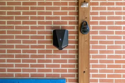 a black object on a brick wall at Villa De Ruiter in Waasmunster