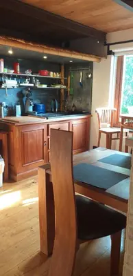 a dining room with a table and a kitchen at Villa Blanco in Opwijk