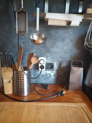 a kitchen counter with a camera on a table at Villa Blanco in Opwijk