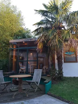 a patio with chairs and a table in front of a house at Villa Blanco in Opwijk