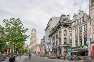 a city street with buildings and people walking on the street at SHWAY - The Card Room Green Studio in Antwerp