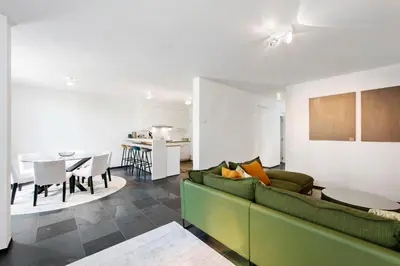a living room with a couch and a dining room at Classy Apartment in City Center with Large Balcony in Ghent