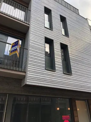 a building with a sign on the side of it at Modern Appartment in the Heart of Ghent in Ghent