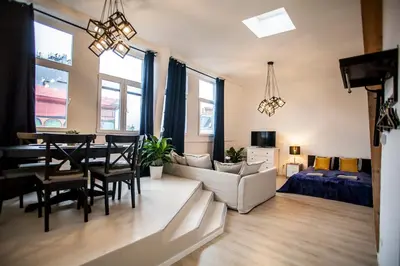 a living room with a table and a dining room at Luxury Suites Grotemarkt by Rikas Hotels in Antwerp