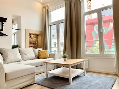 a living room with a couch and a table at Luxury Suites Grotemarkt by Rikas Hotels in Antwerp