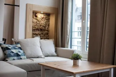 a living room with a couch and a table at Luxury Suites Grotemarkt by Rikas Hotels in Antwerp