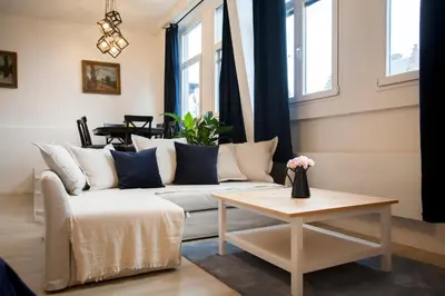 a living room with a couch and a table at Luxury Suites Grotemarkt by Rikas Hotels in Antwerp