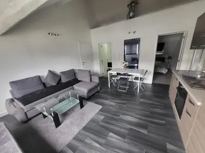 a living room with a couch and a table at City Brussels Apartments in Brussels