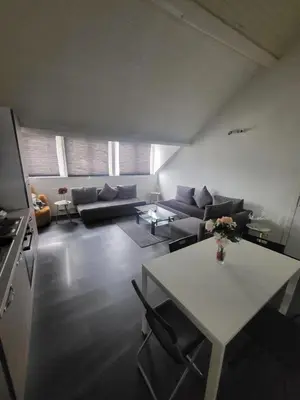 a living room with a couch and a table at City Brussels Apartments in Brussels