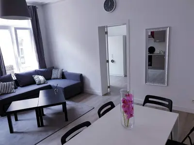 a living room with a couch and a table at City Brussels Apartments in Brussels