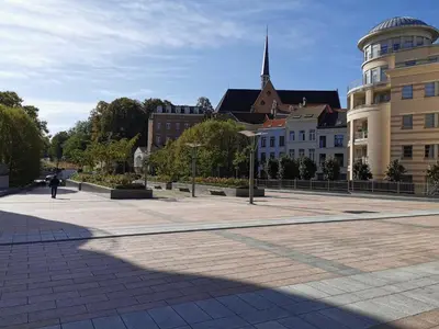 a square in a city with buildings and a church at Cosy Europarlament apartment in Brussels