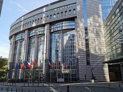 a building with flags in front of it at Cosy Europarlament apartment in Brussels
