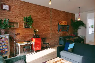 a living room with a brick wall and a couch at 130sqm appartment with 20sqm terras and free parking in Antwerp