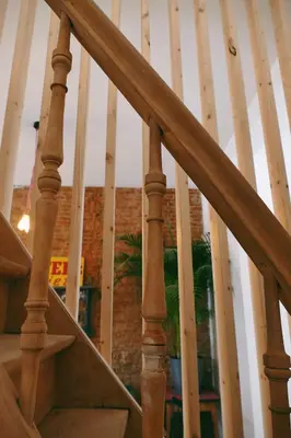a staircase with wooden railings in a house at 130sqm appartment with 20sqm terras and free parking in Antwerp