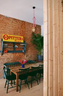 a brick wall with a wooden table and chairs at 130sqm appartment with 20sqm terras and free parking in Antwerp