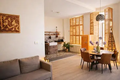 a living room with a couch and a table at SLEEP INN - 1001 Nights Loft Citycenter with Balconyview in Antwerp