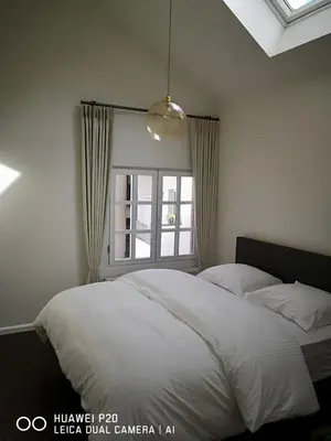 a bedroom with a white bed and a window at Entire House In Centre of Ghent in Ghent