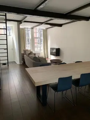 a living room with a large table and chairs at Entire House In Centre of Ghent in Ghent