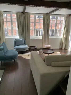 a living room with a couch and two chairs and windows at Entire House In Centre of Ghent in Ghent