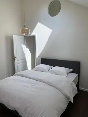 a bedroom with a large bed with white sheets at Entire House In Centre of Ghent in Ghent