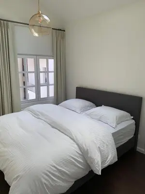 a large white bed in a bedroom with a window at Entire House In Centre of Ghent in Ghent