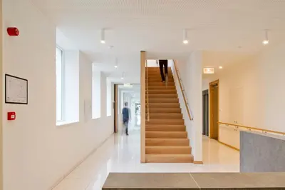 a staircase in a building with a person walking down it at Hotel Den Briel in Ghent