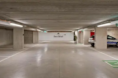 an empty parking garage with a person walking in it at Hotel Den Briel in Ghent
