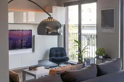 a living room with a couch and a blue chair at London 993 Apt 202 in Antwerp