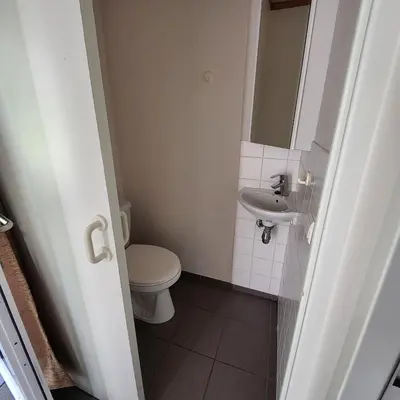 a small bathroom with a toilet and a sink at Kromven in Merksplas