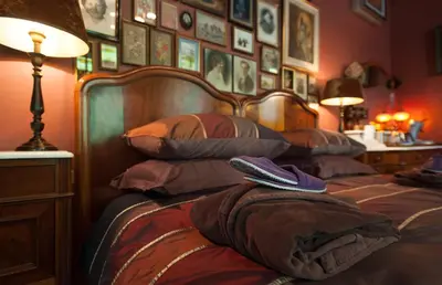 a bed with two remote controls on top of it at B&B De Lachende Engel in Mechelen