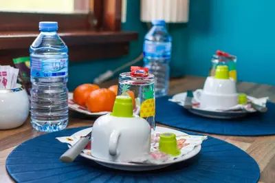 a table with two plates of food and bottles of water at B&B B³ Boat in Ghent