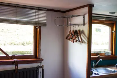 a kitchen with a window and a counter with utensils at B&B B³ Boat in Ghent