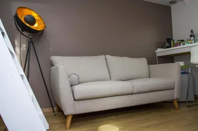 a living room with a couch and a lamp at B&B B³ Boat in Ghent