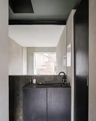 a kitchen with a black counter and a window at Shelter 7 in Ghent