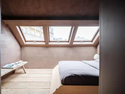 a bedroom with a bed and two windows at Shelter 7 in Ghent