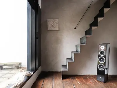 a living room with a staircase and a speaker at Shelter 7 in Ghent