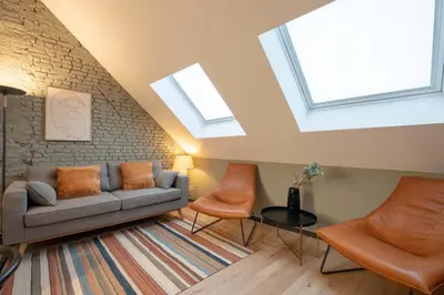 a living room with skylights and a couch and chairs at SHWAY - The Pink Pigeon in Antwerp